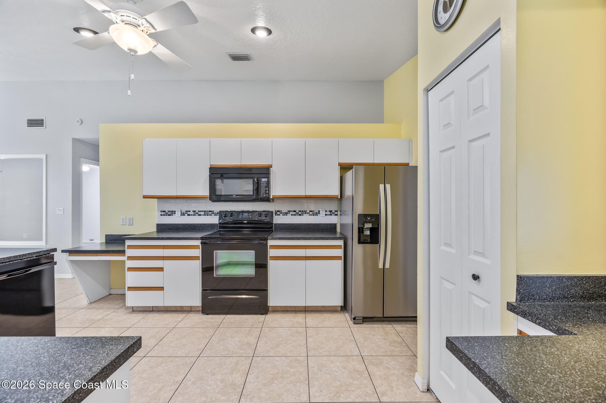 4600 Comfort Street Cocoa, FL 32927 - Photo 6 of 29 a kitchen with stainless steel appliances granite countertop a refrigerator and a stove