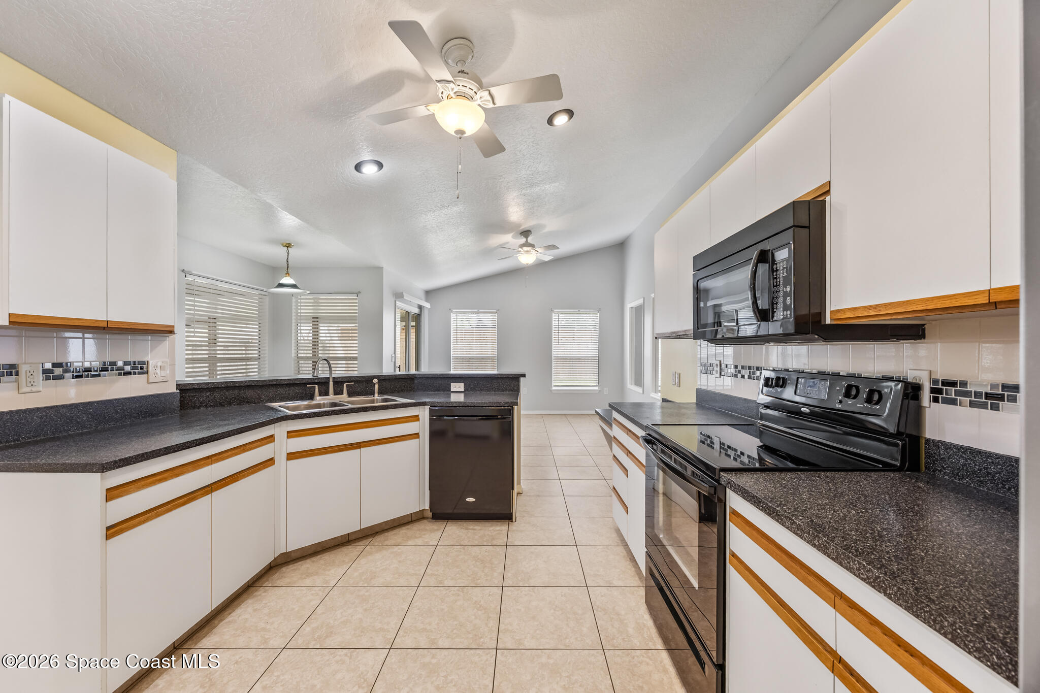 4600 Comfort Street Cocoa, FL 32927 - Photo 7 of 29 a large kitchen with stainless steel appliances granite countertop a stove sink and cabinets