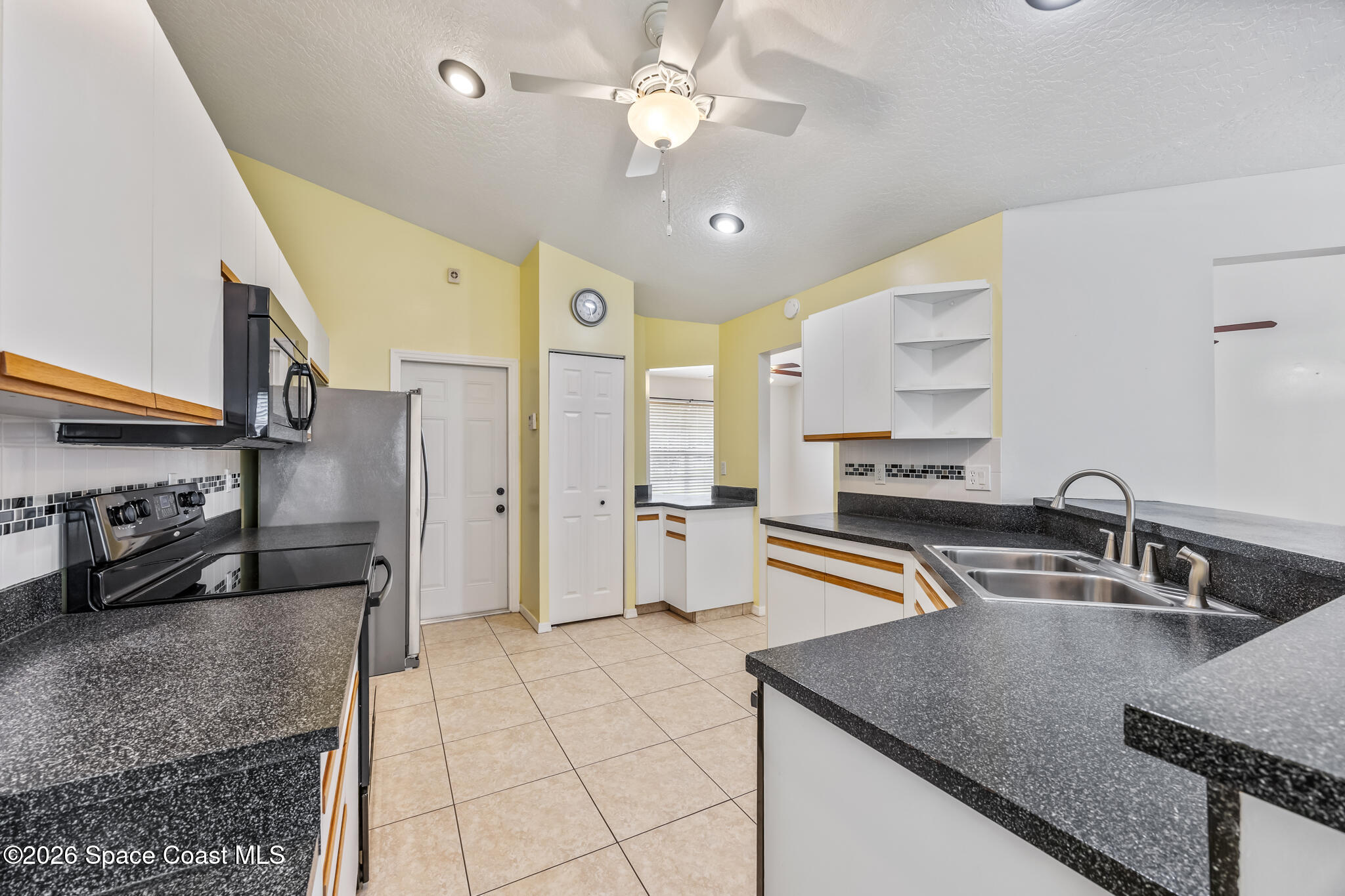 4600 Comfort Street Cocoa, FL 32927 - Photo 8 of 29 a kitchen with stainless steel appliances granite countertop a sink a stove and a refrigerator