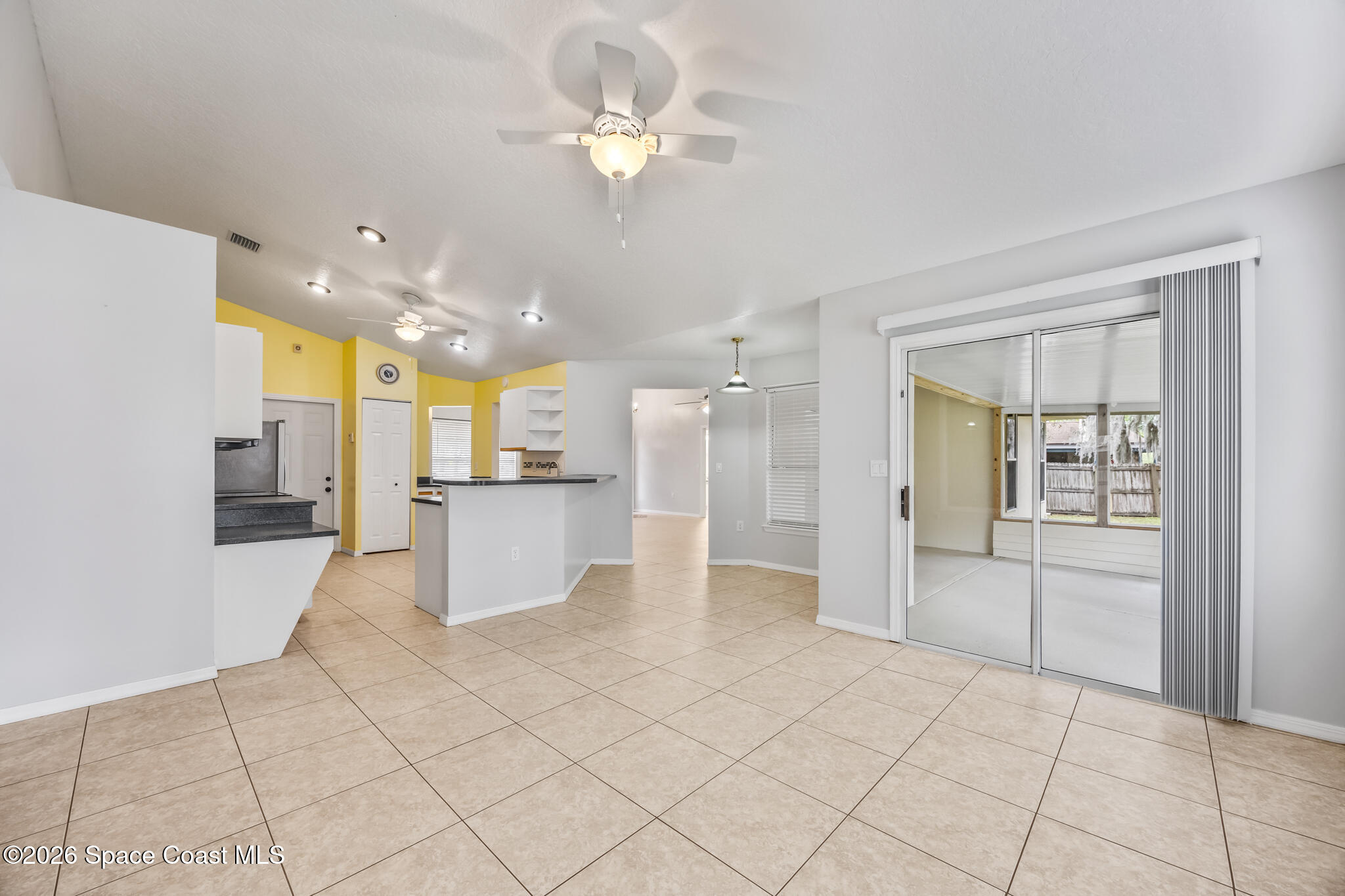 4600 Comfort Street Cocoa, FL 32927 - Photo 9 of 29 a view of a kitchen with kitchen island granite countertop a refrigerator and a sink