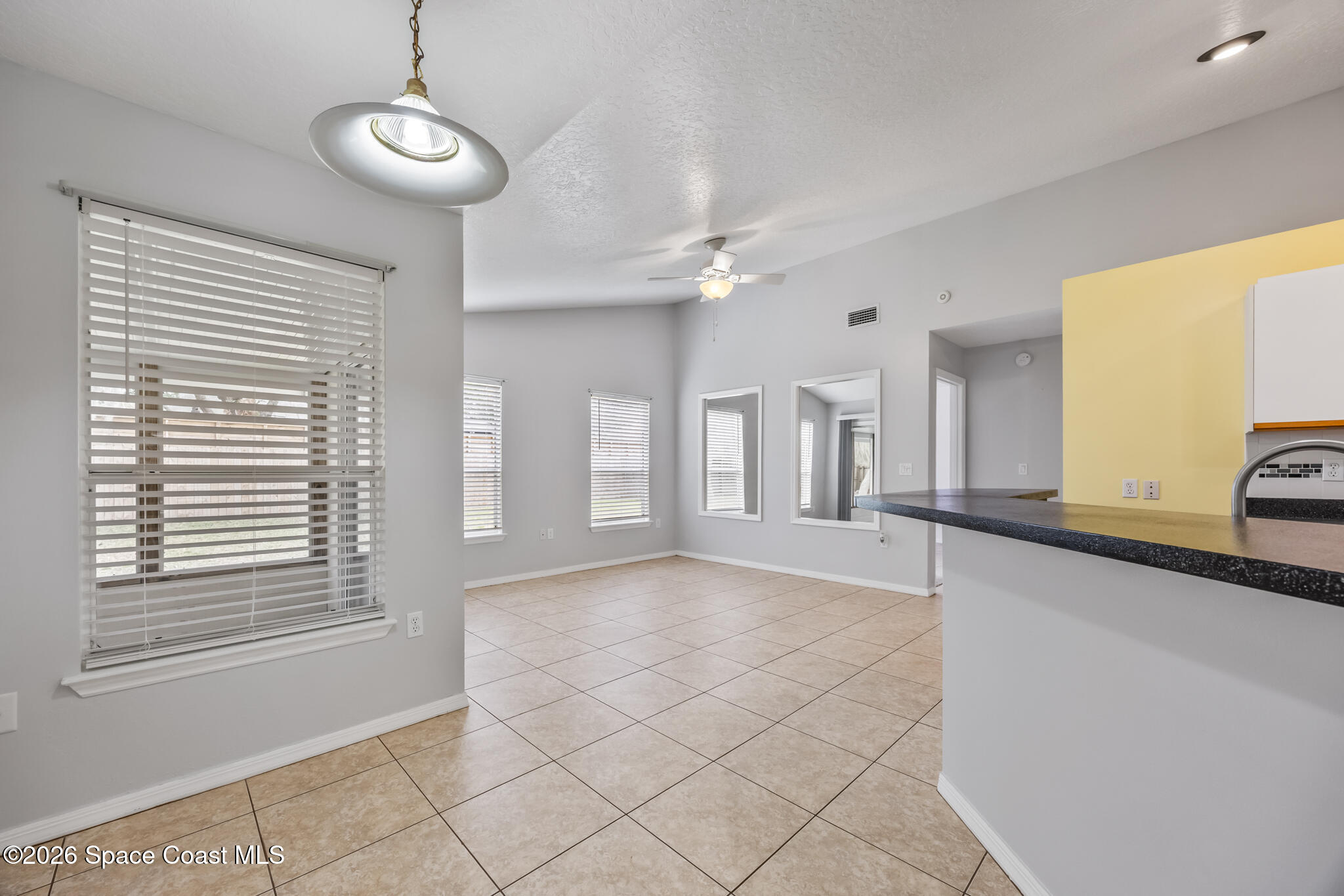 4600 Comfort Street Cocoa, FL 32927 - Photo 10 of 29 a view of an empty room with window and chandelier