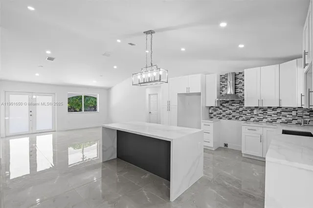 a view of a hallway with wooden cabinets and glass door