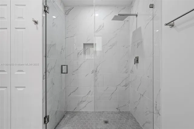 a white bath tub sitting next to a white toilet