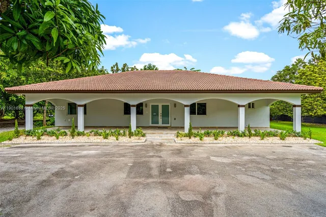 a front view of a house with a garden