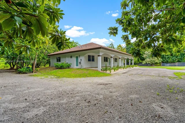 a view of house with outdoor space and swimming pool