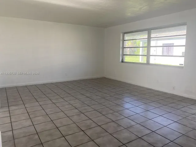 a view of an empty room and window