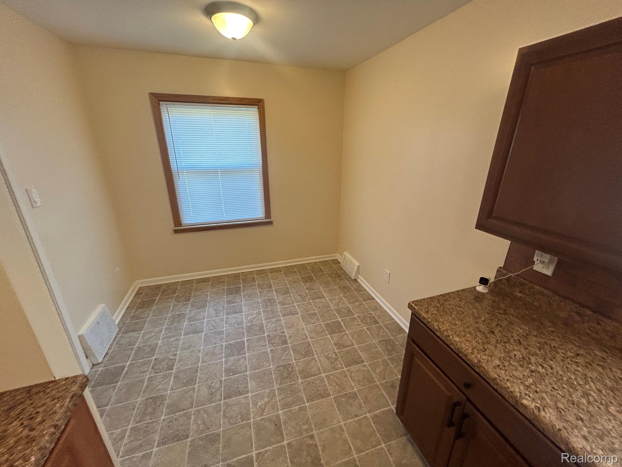 21970 Moross Road Grosse Pointe, MI 48236 - Photo 8 of 21 Compact room featuring diamond-patterned tile flooring and light-toned wall paint