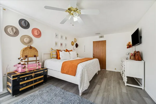 a bedroom with a bed and a chandelier
