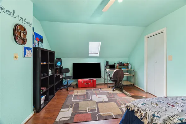 a bedroom with a bed and wooden floor