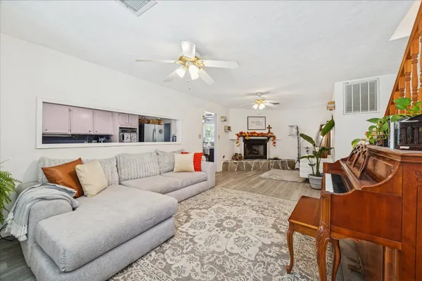 a living room with furniture and a chandelier