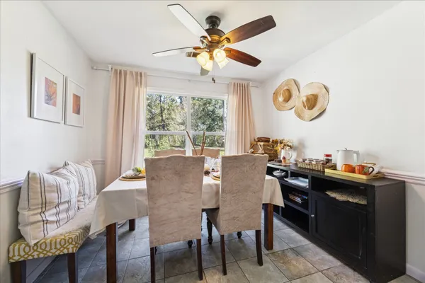 a dining room with furniture a window and a chandelier