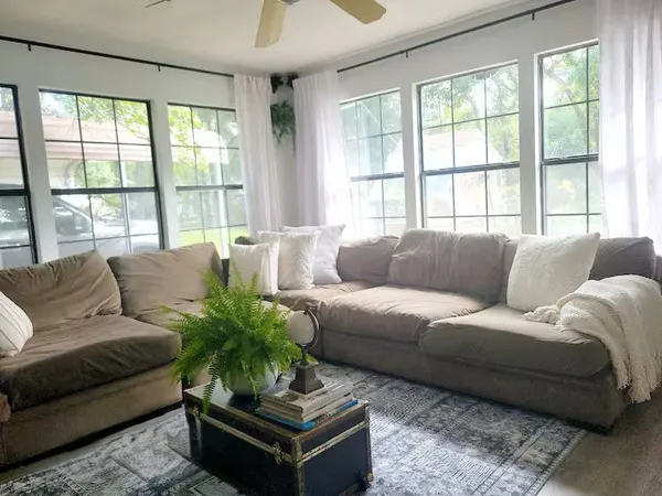 a living room with furniture and windows