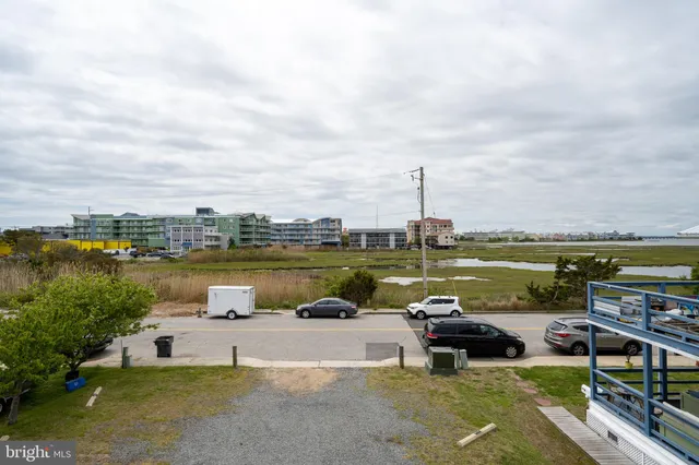 a view of a lake with houses in the back