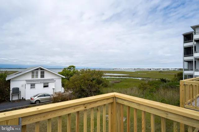 a view of house with ocean from a balcony