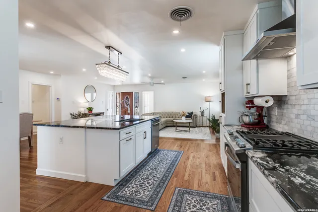 a kitchen with granite countertop lots of counter top space and stainless steel appliances