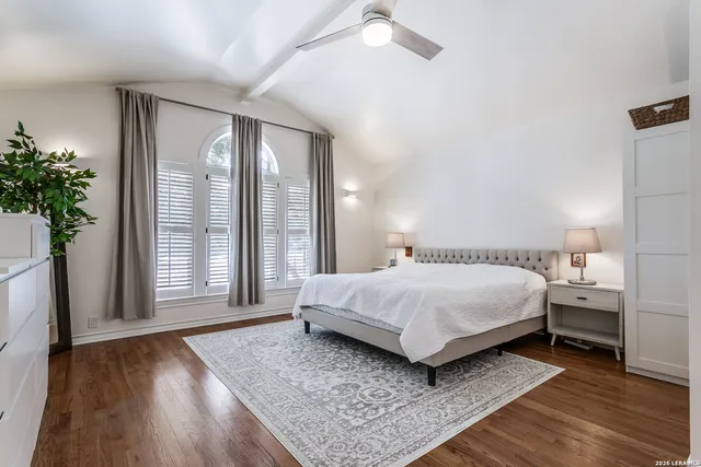 a bedroom with a bed lamp closet and large window
