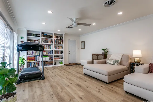 a bedroom with furniture and a book shelf