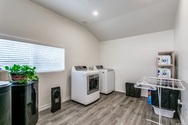 a view of a kitchen with furniture and a potted plant