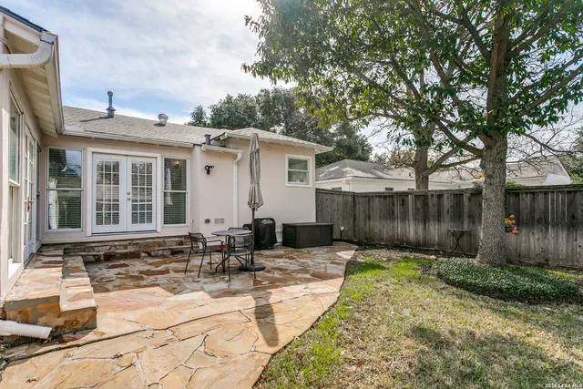a backyard of a house with yard and outdoor seating