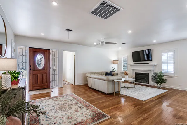 a living room with fireplace furniture and a flat screen tv