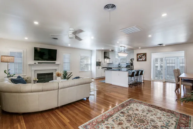 a living room with fireplace furniture and a wooden floor