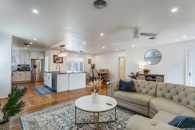 a living room with furniture and kitchen view