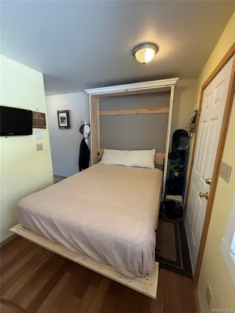 a bedroom with a bed and a mirror