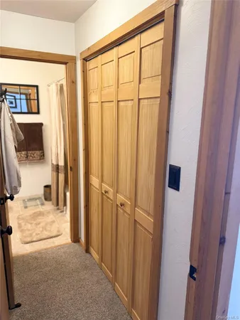 a view of a livingroom with wooden floor and a flat screen tv