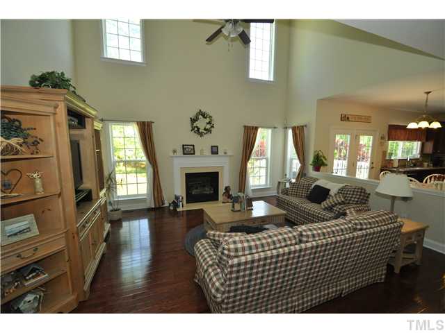 2109 Wide River Drive Raleigh, NC 27614 - Photo 4 of 20 a living room with furniture a fireplace and a flat screen tv