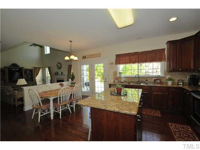 2109 Wide River Drive Raleigh, NC 27614 - Photo 8 of 20 a kitchen with a dining table chairs and a refrigerator