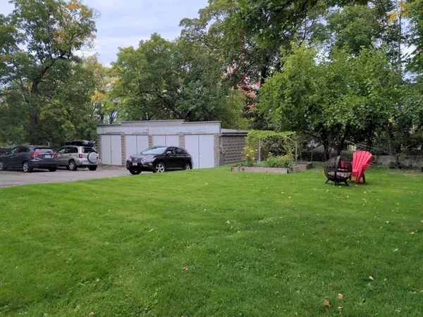 a car parked in front of a house with a yard