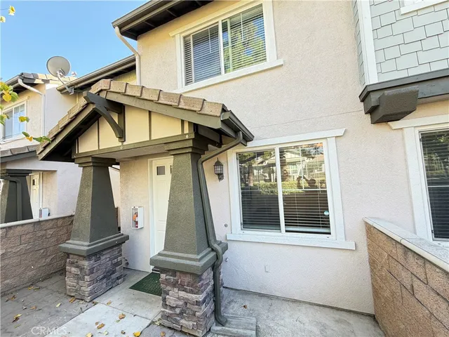 a view of a house with a window and chair