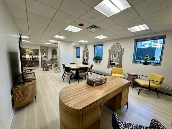 a living room with furniture a wooden floor and a large window