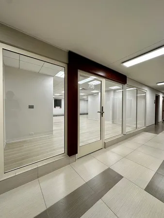 a big room with wooden floor and windows