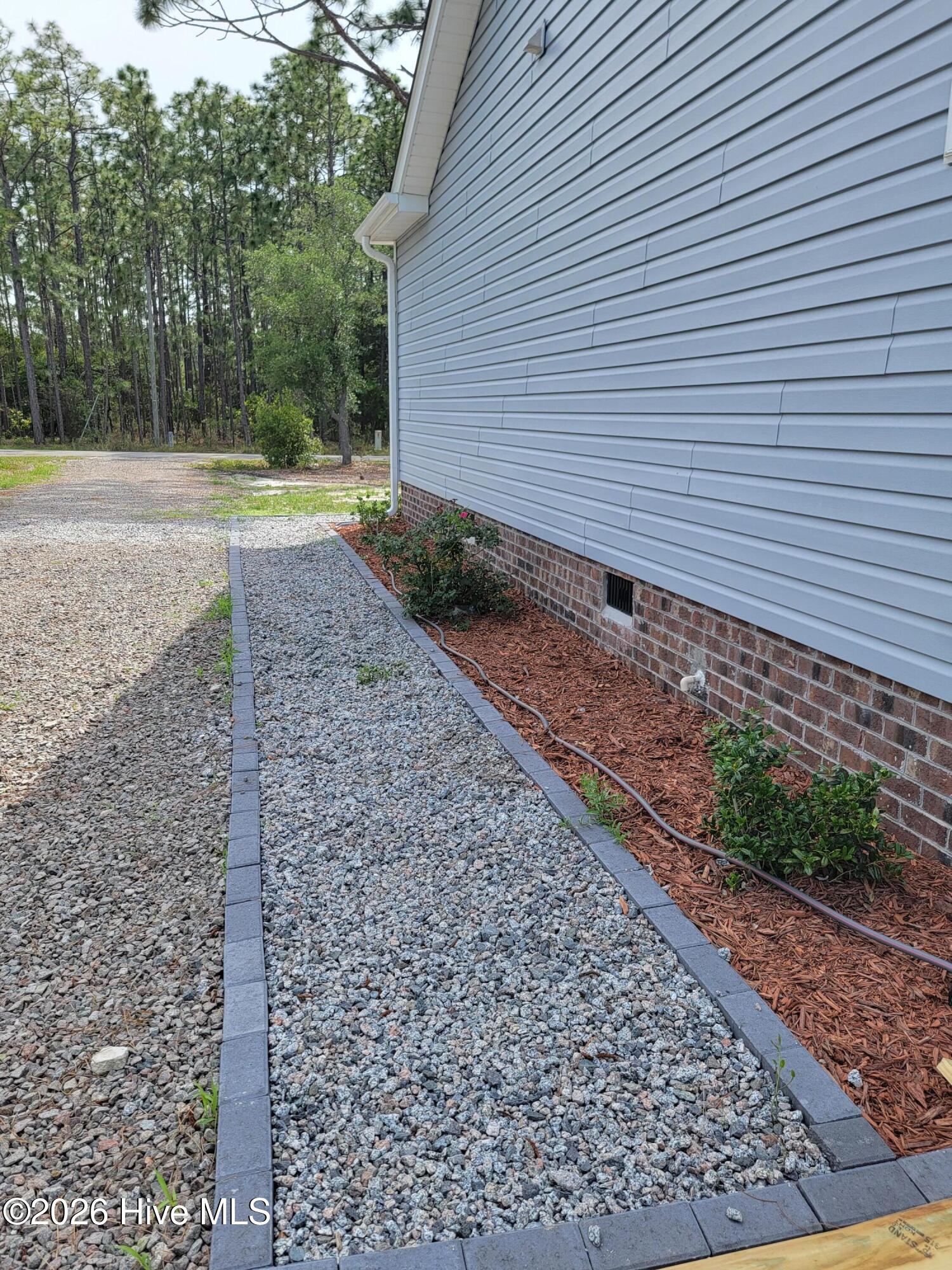 1053 Springdale Road Southport, NC 28461 - Photo 29 of 32 Side gravel walkway