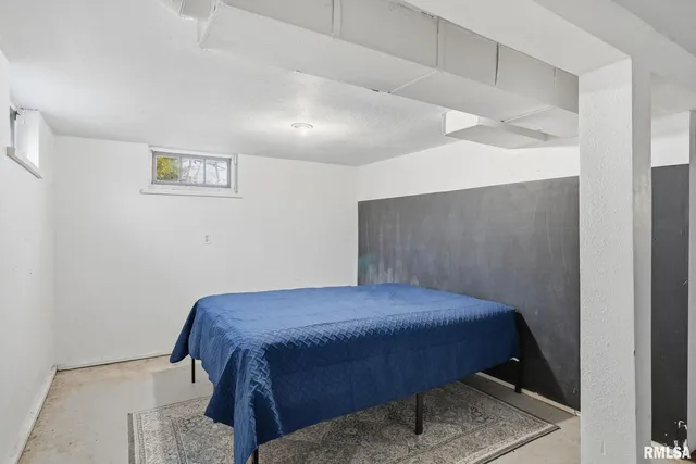 a bedroom with a bed and lamp