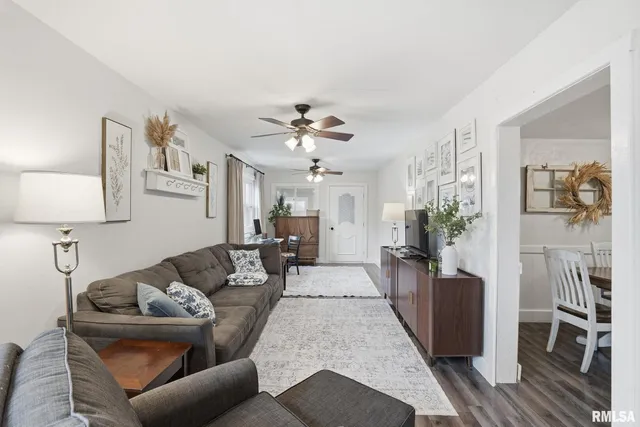 a living room with furniture and a chandelier