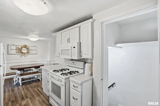 a kitchen with a stove and a refrigerator