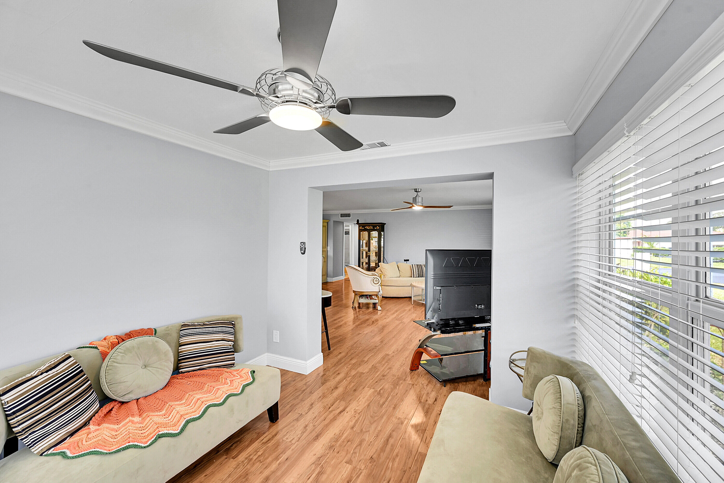4585 Northwest 3rd Street, Unit D Delray Beach, FL 33445 - Photo 12 of 45 a living room with furniture and a chandelier