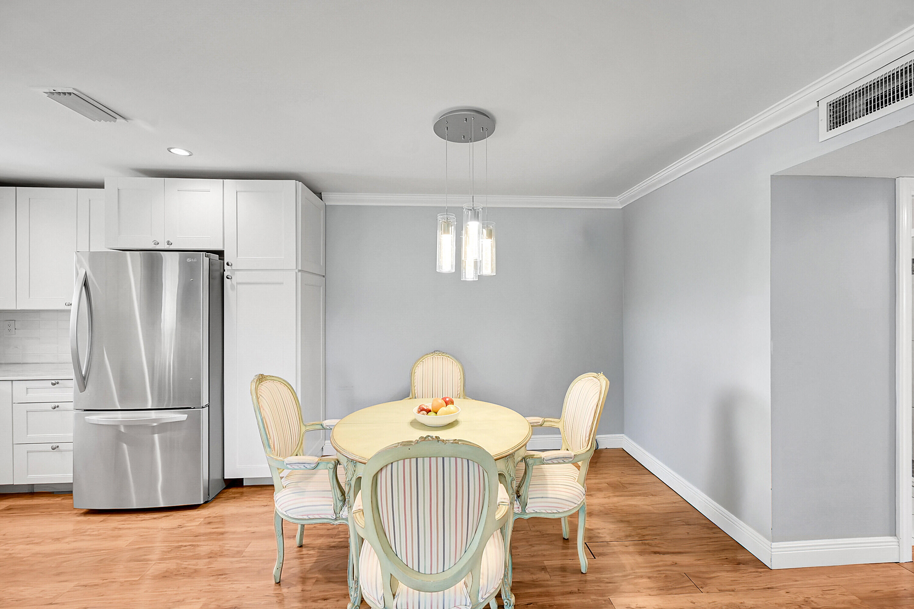 4585 Northwest 3rd Street, Unit D Delray Beach, FL 33445 - Photo 14 of 45 a kitchen with stainless steel appliances granite countertop a refrigerator a stove a sink dishwasher with a dining table and chairs