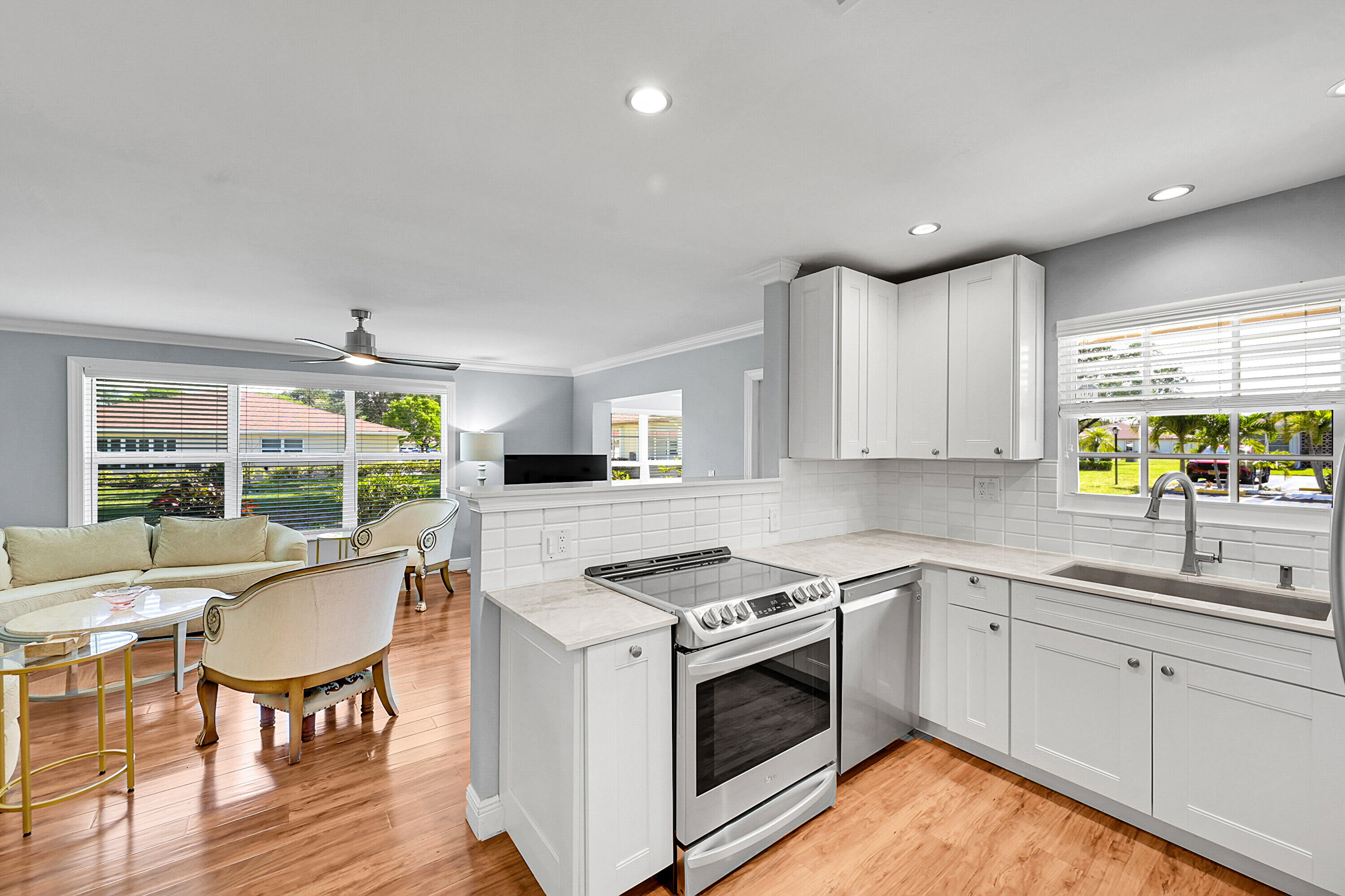 4585 Northwest 3rd Street, Unit D Delray Beach, FL 33445 - Photo 17 of 45 a kitchen with a stove a sink and a refrigerator