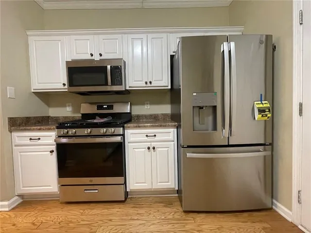 a kitchen with cabinets and steel stainless steel appliances