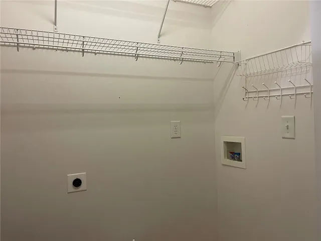 a view of an empty room with a chandelier fan