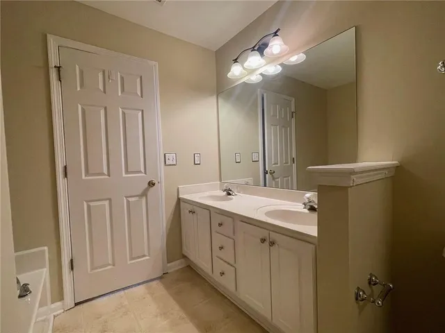 a bathroom with a double vanity sink and a mirror