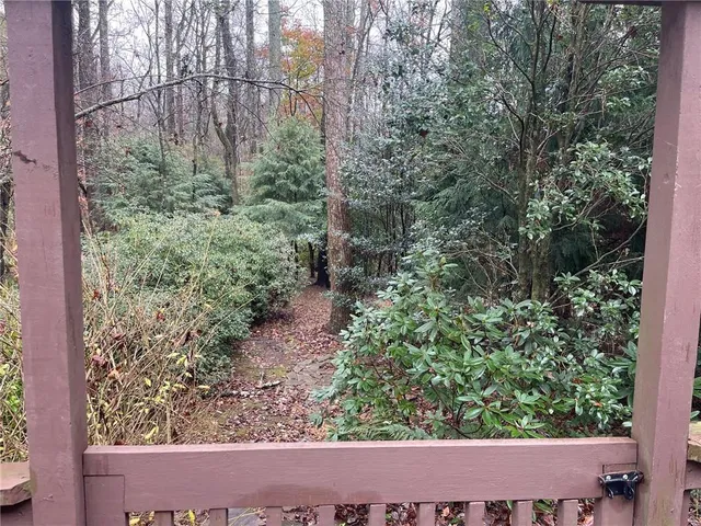 a view of a house with a yard balcony and mountain view