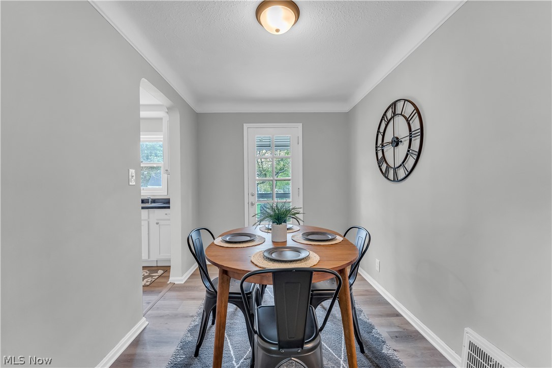 1828 South Green Road Cleveland, OH 44121 - Photo 9 of 30 Dining room featuring ornamental molding and dark hardwood / wood-style flooring