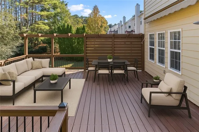 a view of a balcony with two chairs and a wooden floor