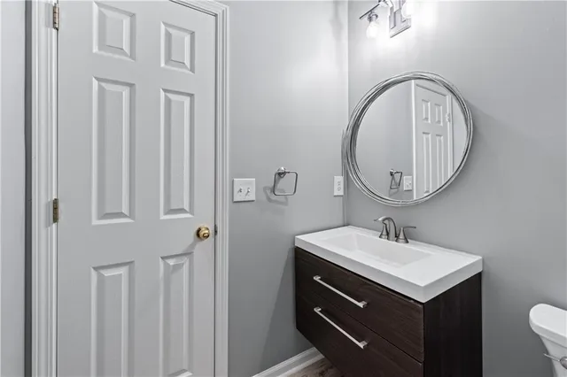 a bathroom with a sink vanity and a mirror