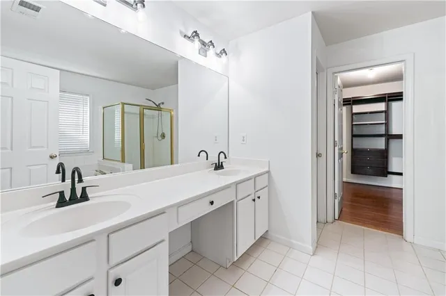 a spacious bathroom with a double vanity sink mirror and