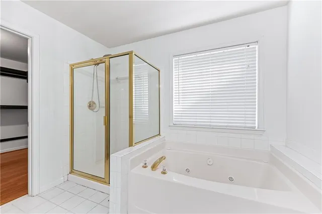 a bathroom with a bathtub and a shower